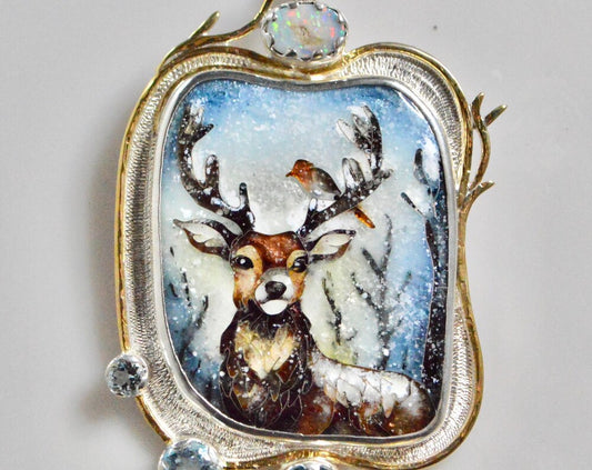 Stag in snowy forest with Robin